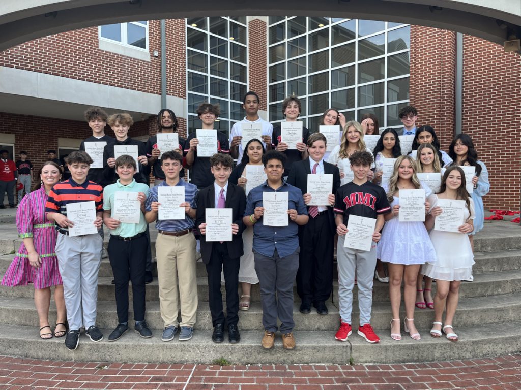 Inductees to the National Junior Honor Society stand with Advisor Mara Zumchak.