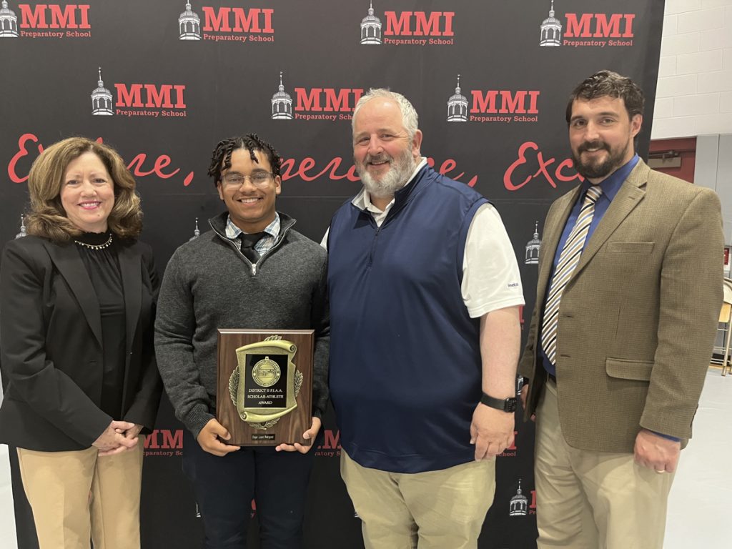 Senior Edgar Lopez-Rodriguez received the 2024 District 2 Pennsylvania Interscholastic Athletic Association Scholar-Athlete Award and stands with Head of School Theresa Long, Athletic Director Joseph Flanagan, and Academic Dean Justin Vincent.